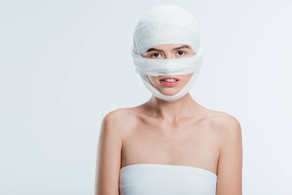 woman with bandages over head isolated on white