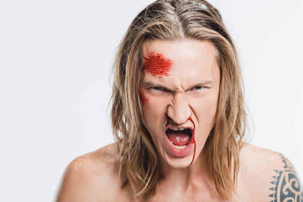 close up of angry shouting man with bloody wounds on face isolated on white