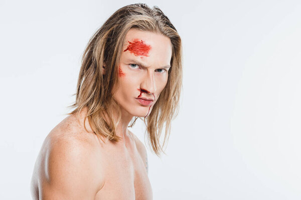 serious angry naked man with blood on face isolated on white