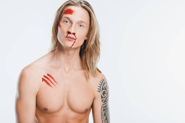 naked handsome man with bloody wounds on skin isolated on white
