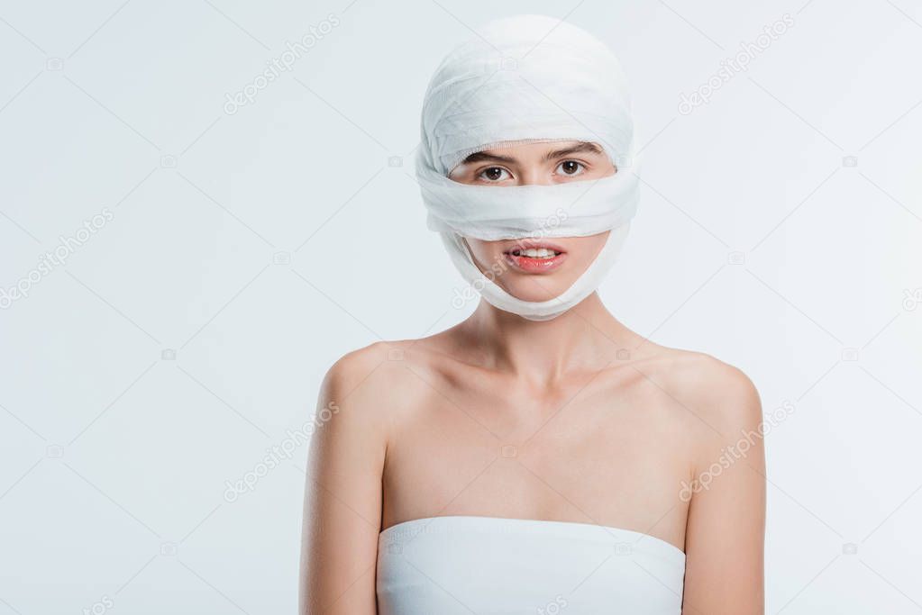 woman with bandages over head isolated on white
