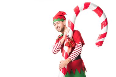 adam Noel elf kostümü beyaz izole taşıyan büyük şeker kamışı gülümseyen