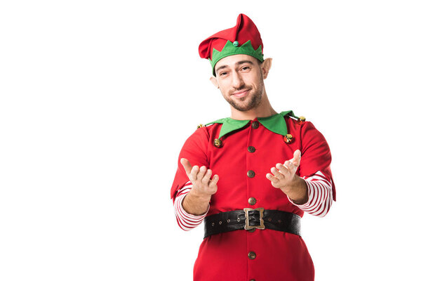 smiling man in christmas elf costume with outstretched hands gesture isolated on white