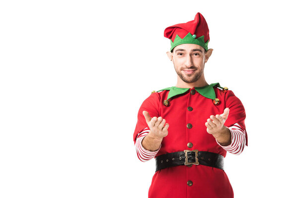 man in christmas elf costume with outstretched hands gesture looking at camera isolated on white