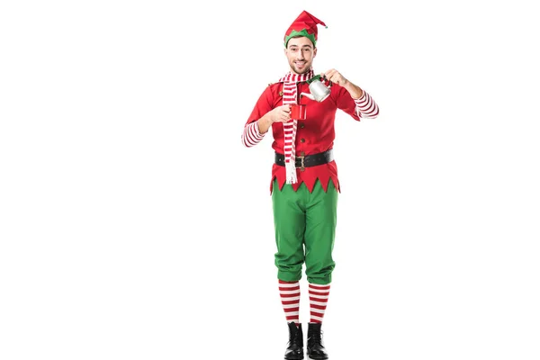 happy man in christmas elf costume holding red cup and metal kettle isolated on white