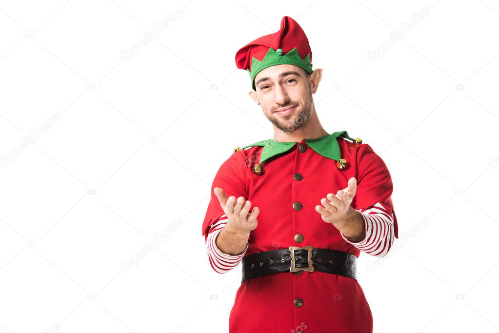 smiling man in christmas elf costume with outstretched hands gesture isolated on white