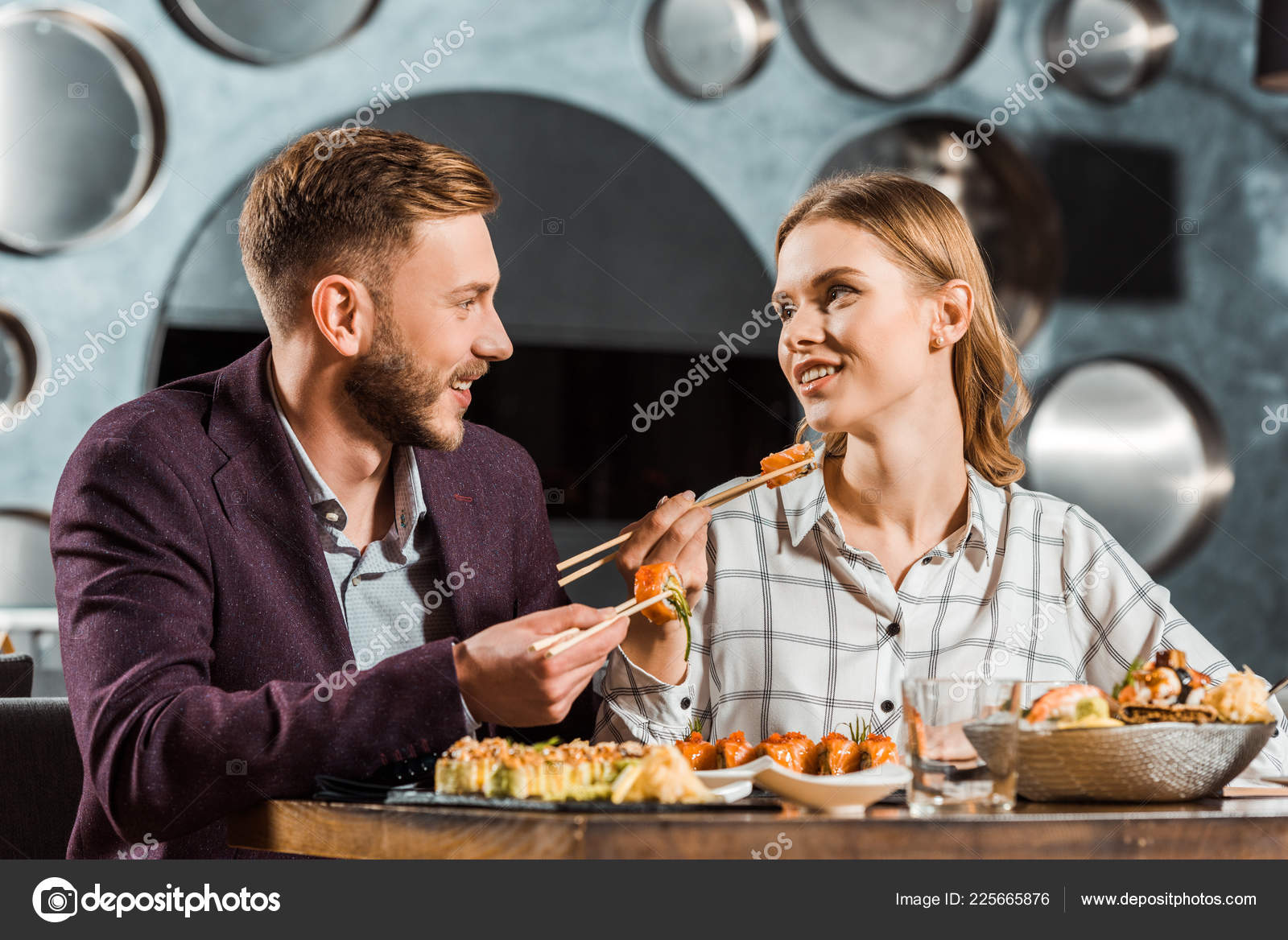 Happy Young Adult Couple Looking Each Other While Having Dinner Stock Photo  by ©EdZbarzhyvetsky 225665876