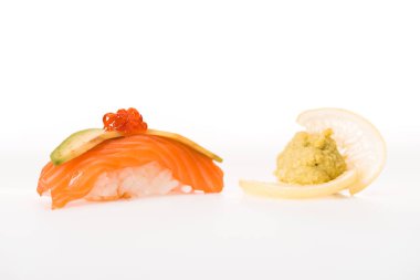 Delicious nagiri sushi with salmon, caviar, avocado and lemon isolated on white clipart