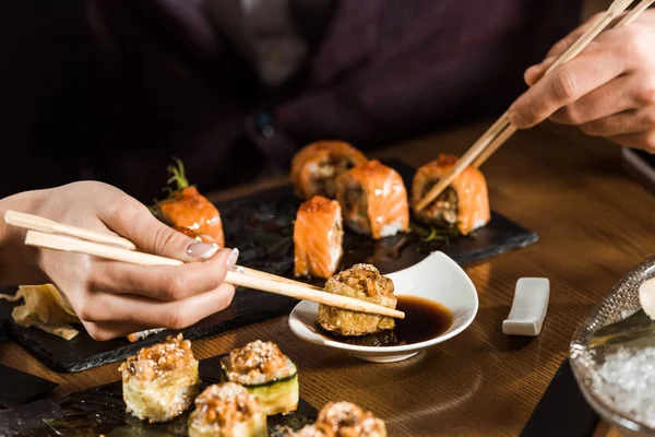 Cropped View People Eating Sushi Chopsticks Restaurant — Stock Photo, Image