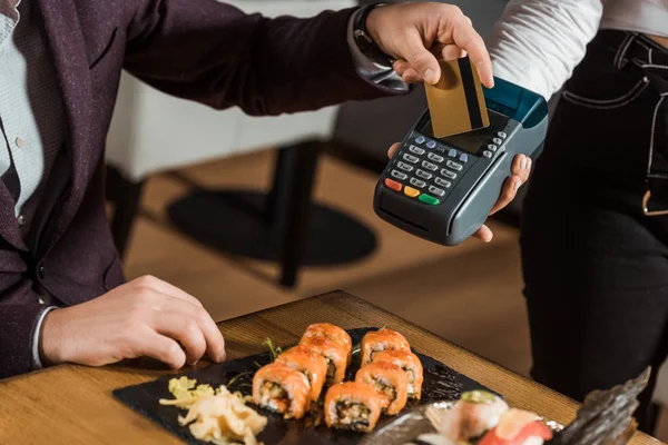 部分查看男子在餐厅用信用卡支付晚餐费用 — 图库照片