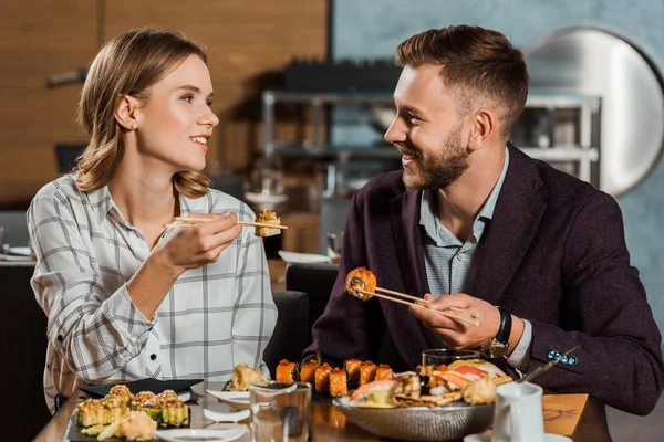 Lovely Couple Amorously Looking Each Other Eating Sushi Rolls Restaurant — Stock Photo, Image