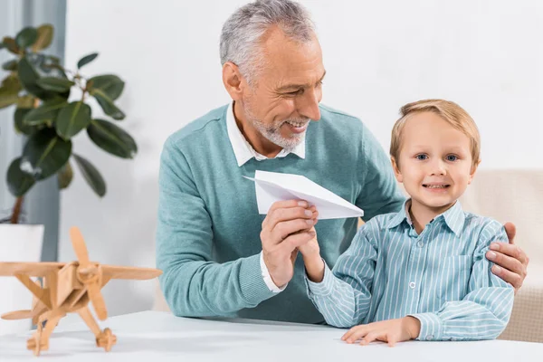 Gelukkig Grootvader Schattige Kleinzoon Plezier Met Papier Vliegtuig Thuis — Stockfoto