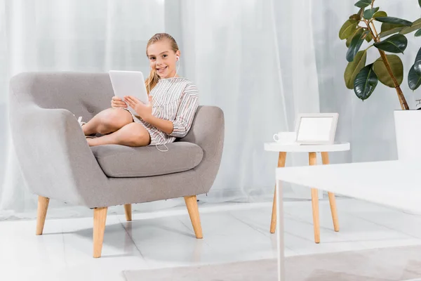 Cheerful Little Child Earphones Sitting Armchair Digital Tablet Home — Stock Photo, Image