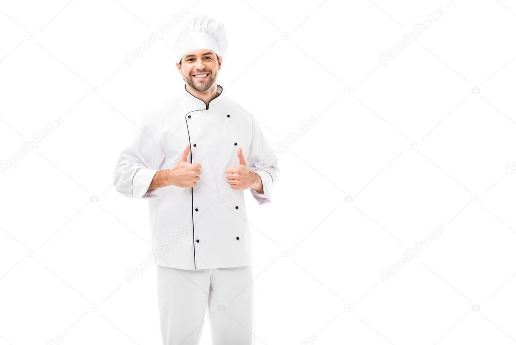 attractive young chef showing thumbs up at camera isolated on white
