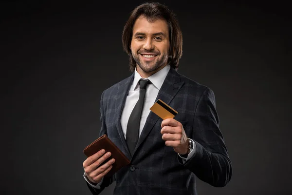 Smiling Young Businessman Holding Wallet Credit Card Isolated Black — Stock Photo, Image