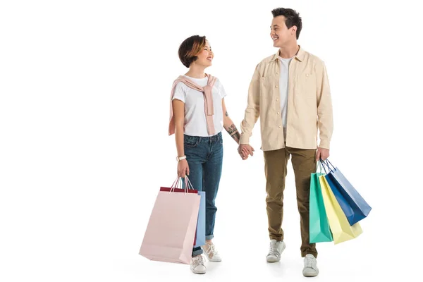 Smiling Couple Looking Each Other Holding Hands Carrying Shopping Bags — Stock Photo, Image