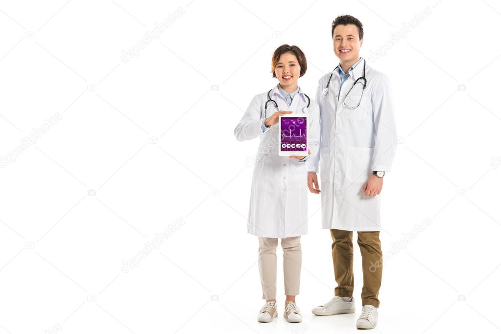 female and male doctors presenting digital tablet with health data app isolated on white