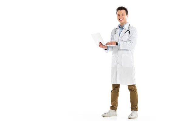 Smiling Male Doctor Standing Holding Laptop Looking Camera Isolated White — Free Stock Photo