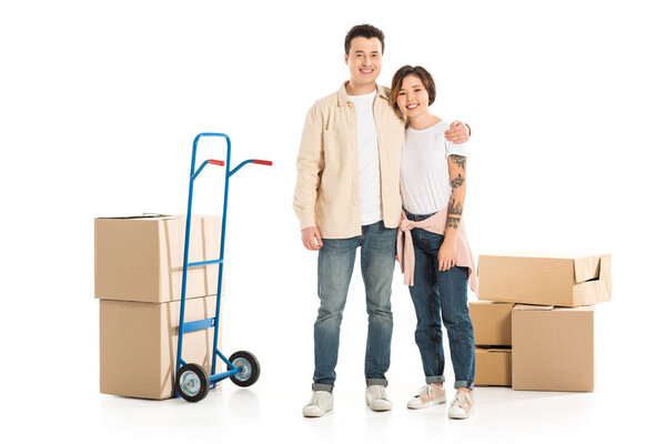 husband hugging wife with cardboard boxes isolated on white, moving to new house concept