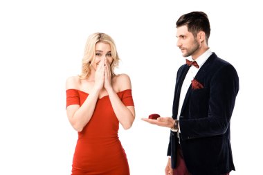 Handsome man proposing surprised girlfriend to marry isolated on white clipart
