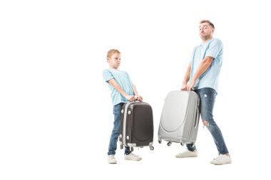 Dad and son holding heavy baggage isolated on white clipart