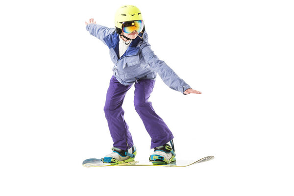 young woman in blue ski suit snowboarding isolated on white