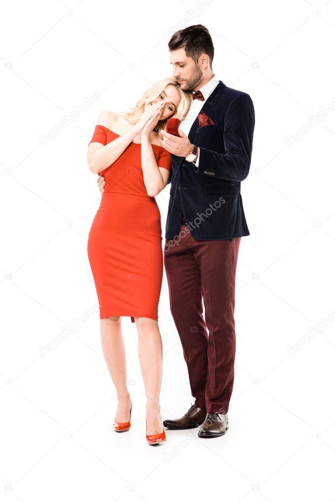 Man proposing surprised girlfriend to marry isolated on white