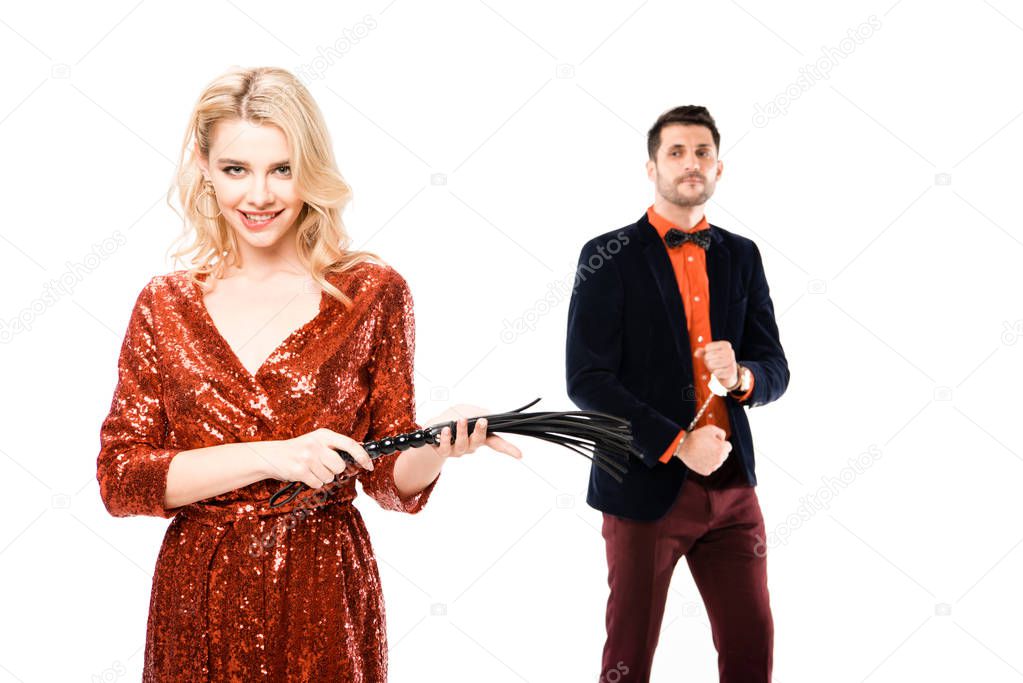 Couple of attractive woman with whip and man in handcuffs isolated on white