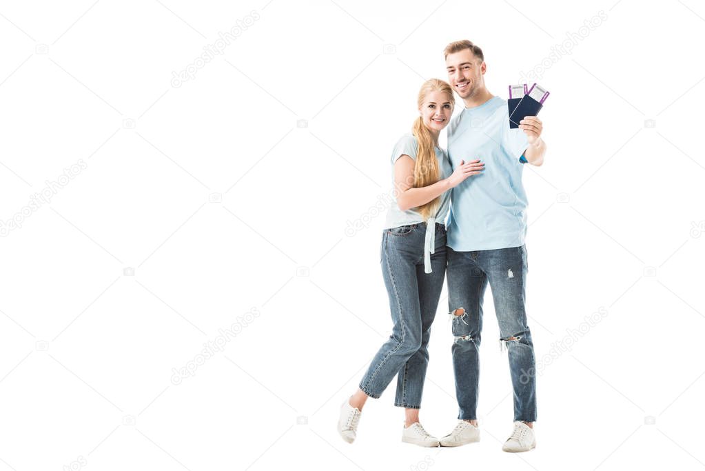 Man holding passports and hugging woman isolated on white 