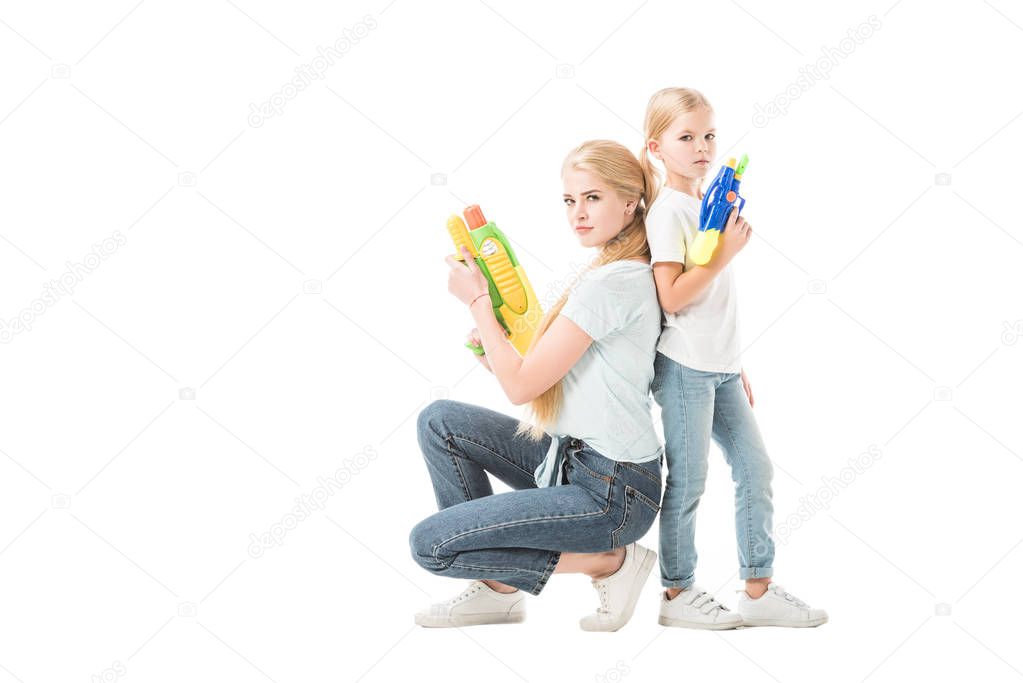 Mom and daughter playing with water guns isolated on white