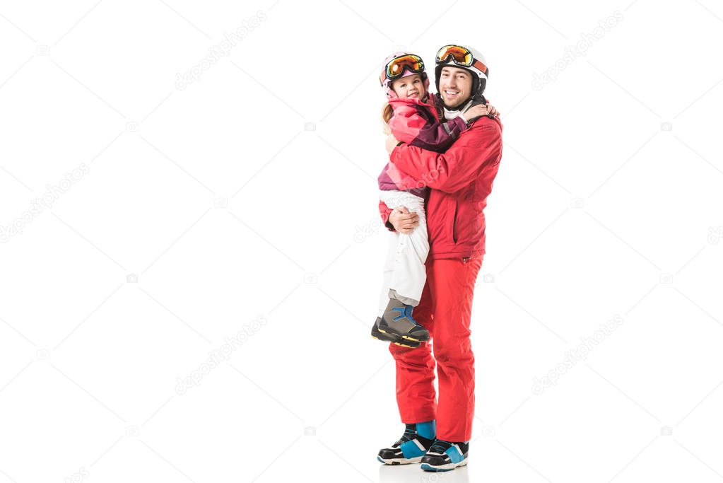 Father standing and holding daughter in snowsuit isolated on white