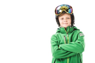 Preteen boy in ski clothes with arms crossed smiling and looking at camera isolated on white
