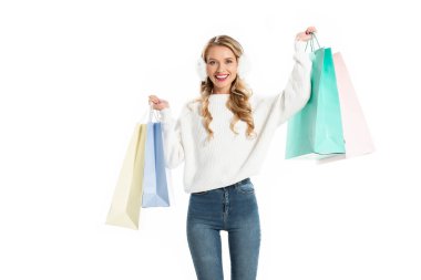 beautiful smiling young woman in winter outfit holding shopping bags isolated on white clipart
