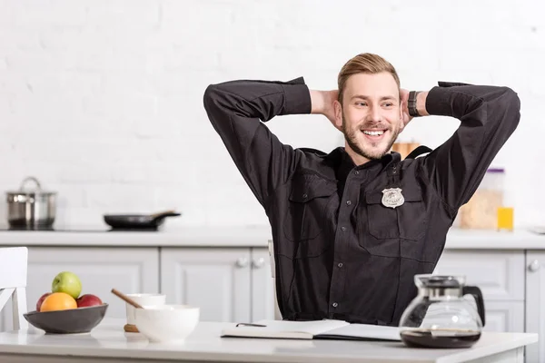 Smiling Police Officer Hands Head Sitting Kitchen Table — Stock Photo, Image