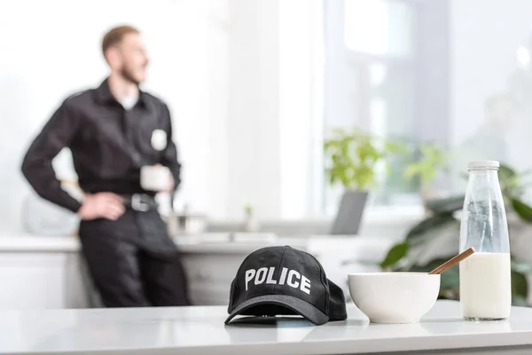 Police Cap Bowl Milk Bottle Kitchen Table Policeman Background — Free Stock Photo