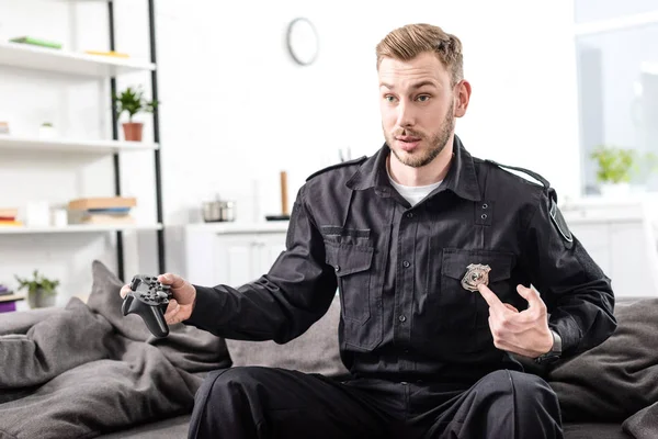 Překvapený Policista Hrát Videohry Ukazovala Policejní Odznak — Stock fotografie zdarma