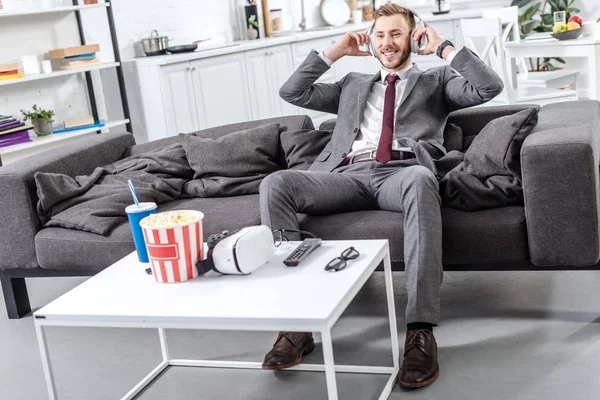 Sonriente Hombre Negocios Auriculares Sentado Relajado Sofá Casa — Foto de stock gratis