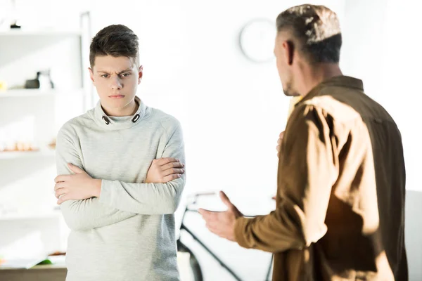 Irritated Father Gesturing Looking Teen Son Crossed Arms Home — Stock Photo, Image