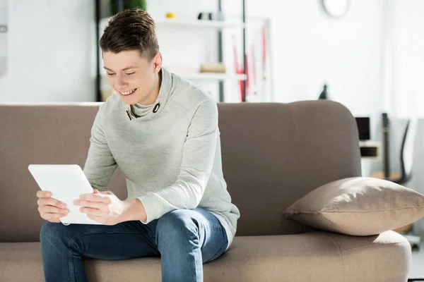 Smiling Teenager Using Tablet Sofa Home — Free Stock Photo