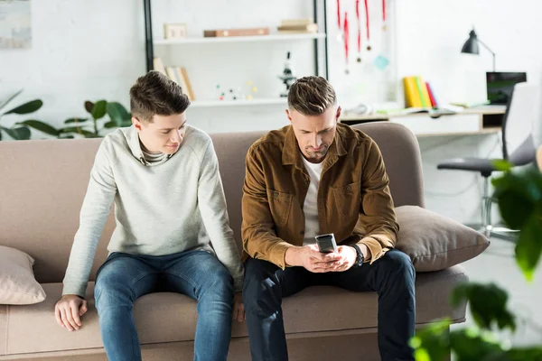 Father Teen Son Sitting Sofa Looking Remote Control — Stock Photo, Image