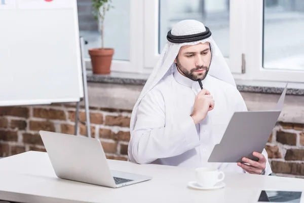 Arabischer Geschäftsmann Blickt Auf Ordner Und Denkt Amt Nach — Stockfoto