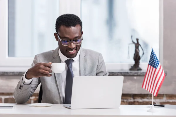 African American Businessman Drinking Coffee Using Laptop — Stock Photo, Image