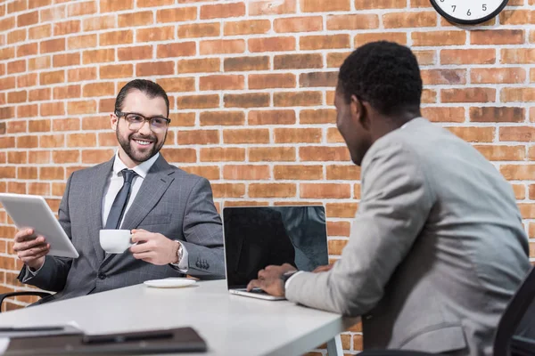 Smiling Businessman Digital Tablet African American Partner Laptop Looking Each — Free Stock Photo