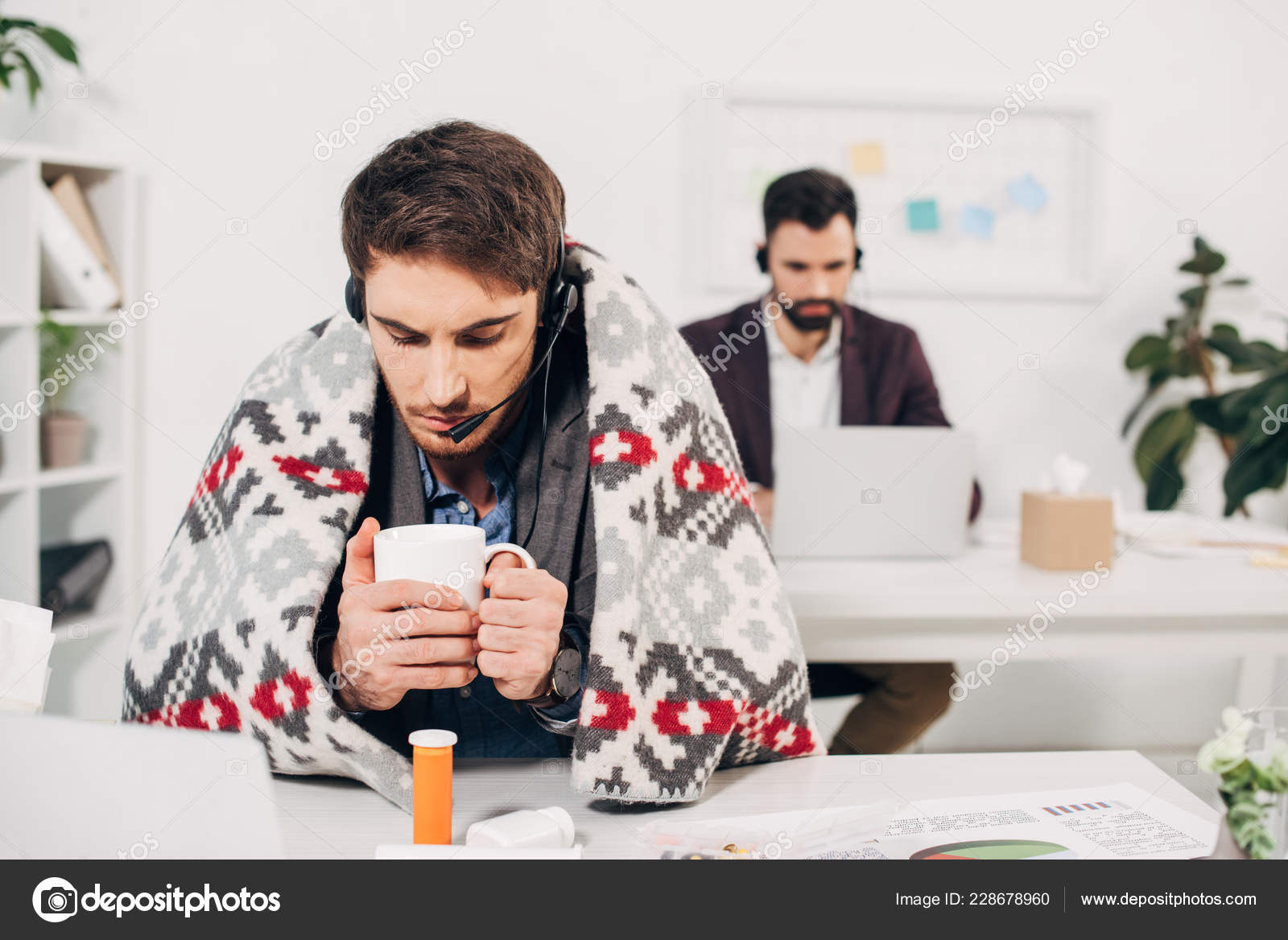 Call Center Operator Blanket Shoulders Holding Cup Sitting Desk