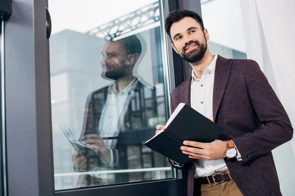 Handsome Businessman Standing Window Writing Notebook — Stock Photo, Image