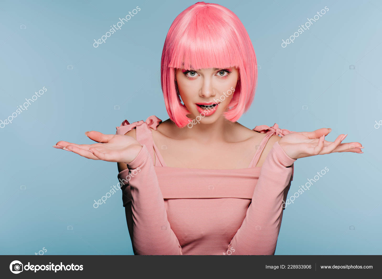Fashionable Shocked Girl Pink Wig Posing Shrug Gesture Isolated Blue