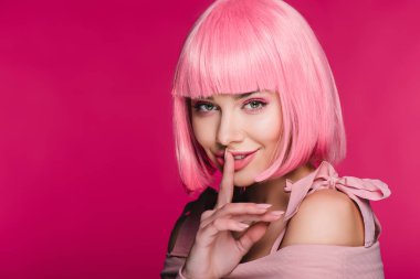 sensual fashionable girl in pink wig showing hush sign, isolated on pink clipart