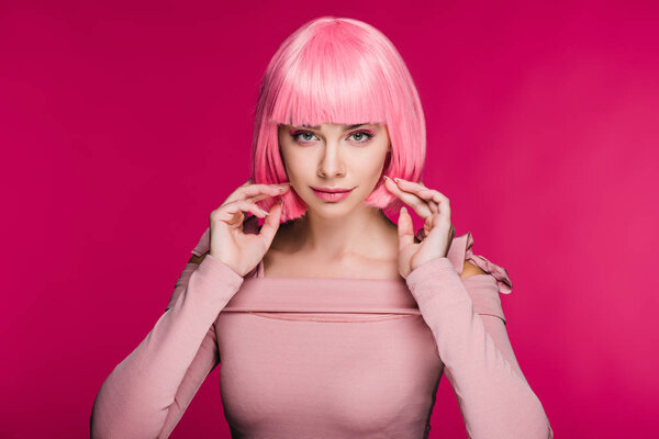 beautiful fashionable girl posing in pink wig for fashion shoot, isolated on pink