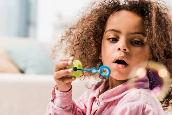 Curly African American Kid Blowing Soap Bubbles Home — Stock Photo, Image