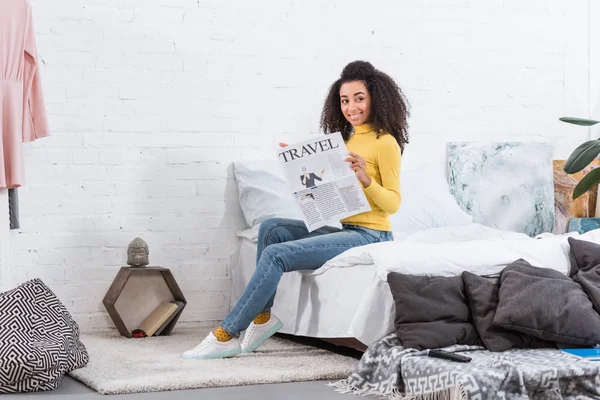 家で旅行の新聞を読んで魅力的なアフリカ系アメリカ人のスタイリッシュな女の子  — 無料ストックフォト